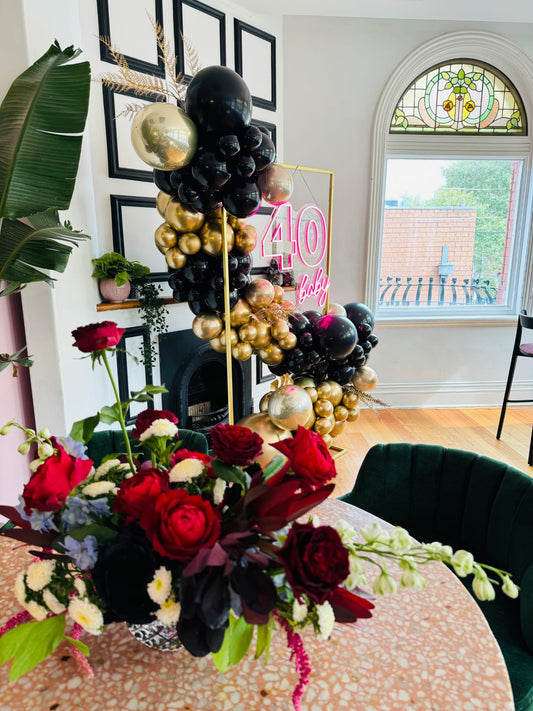Black and gold balloon garland with faux flowers custom neon sign Melbourne