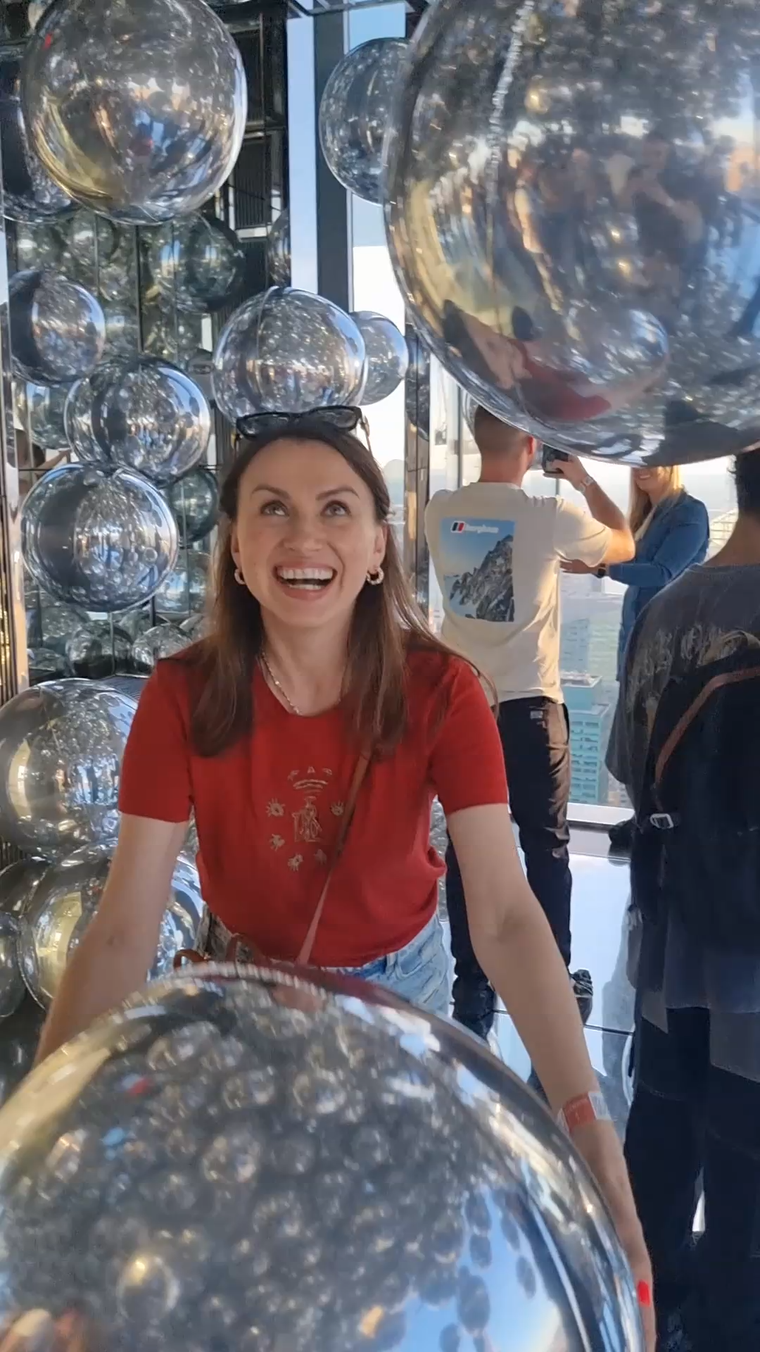 Evija Litvinova at Summit One Vanderbilt NYC throwing a silver balloon