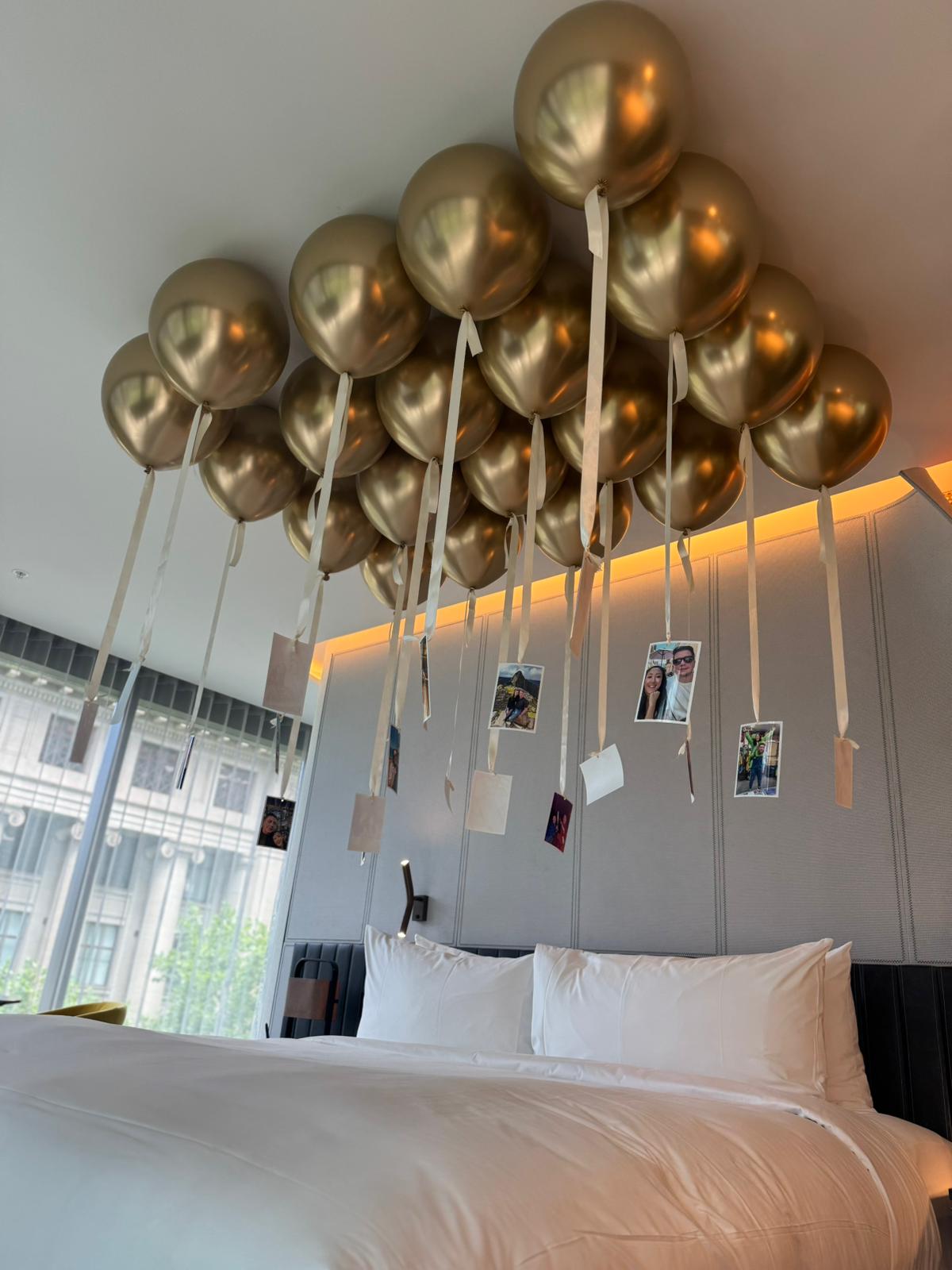 Free flowing gold balloons helium on a hotel ceiling with romantic photographs in Melbourne CBD 