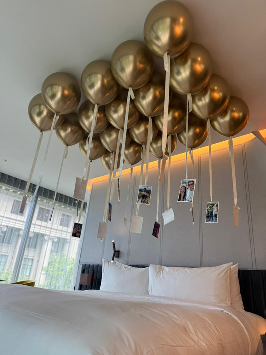 Free flowing gold balloons helium on a hotel ceiling with romantic photographs in Melbourne CBD 