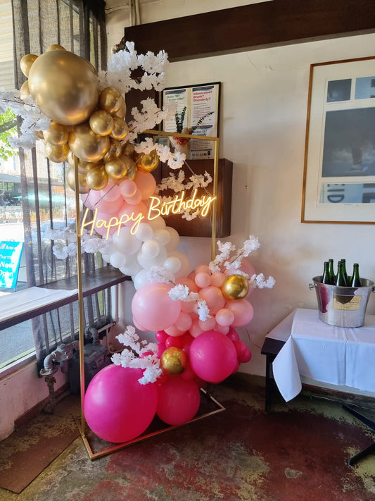 Pink Garland with White Faux Flowers and a "Happy Birthday" Neon