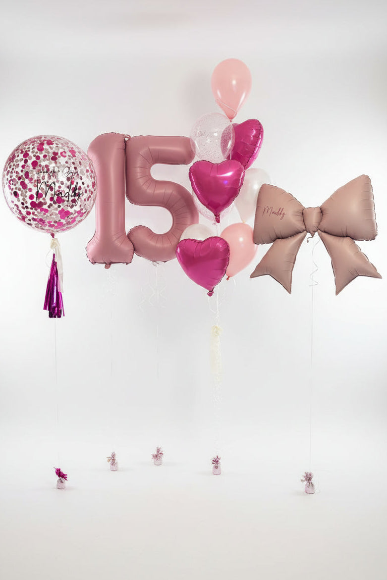 Globos con números negros y dorados con un gran ramo de globos de helio (llenos de helio)