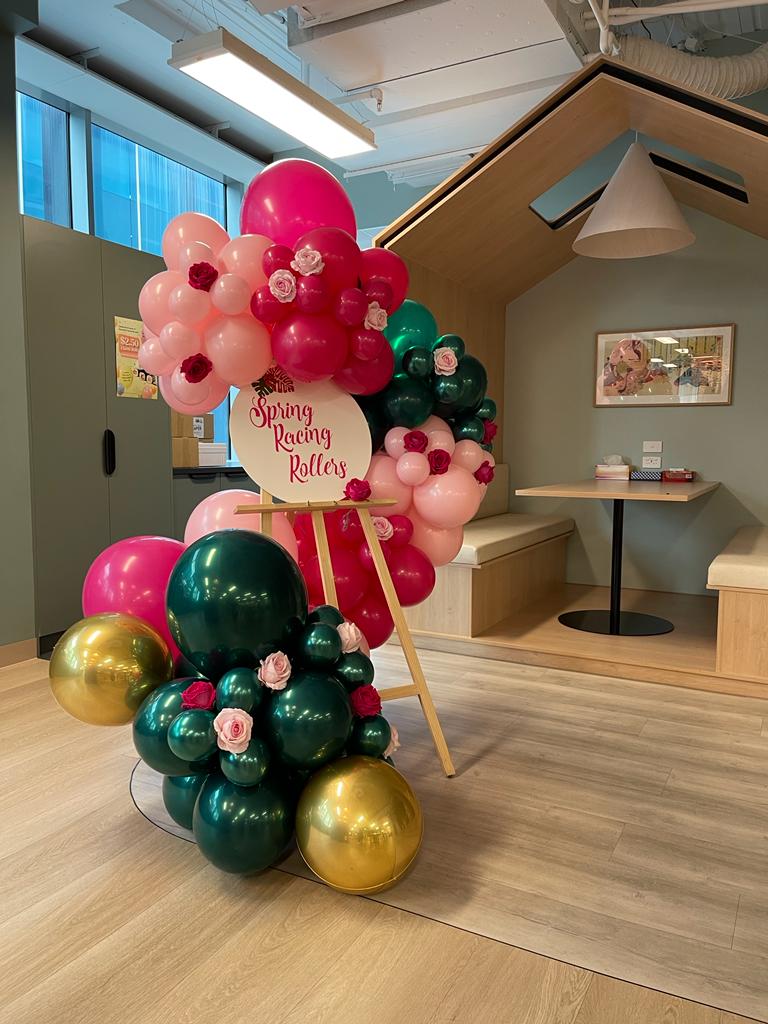 Spring Racing Balloon Garland on an easel with flowers in Richmond Venue