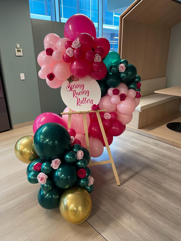 Spring Racing Balloon Garland on an easel with flowers in melbourne venue