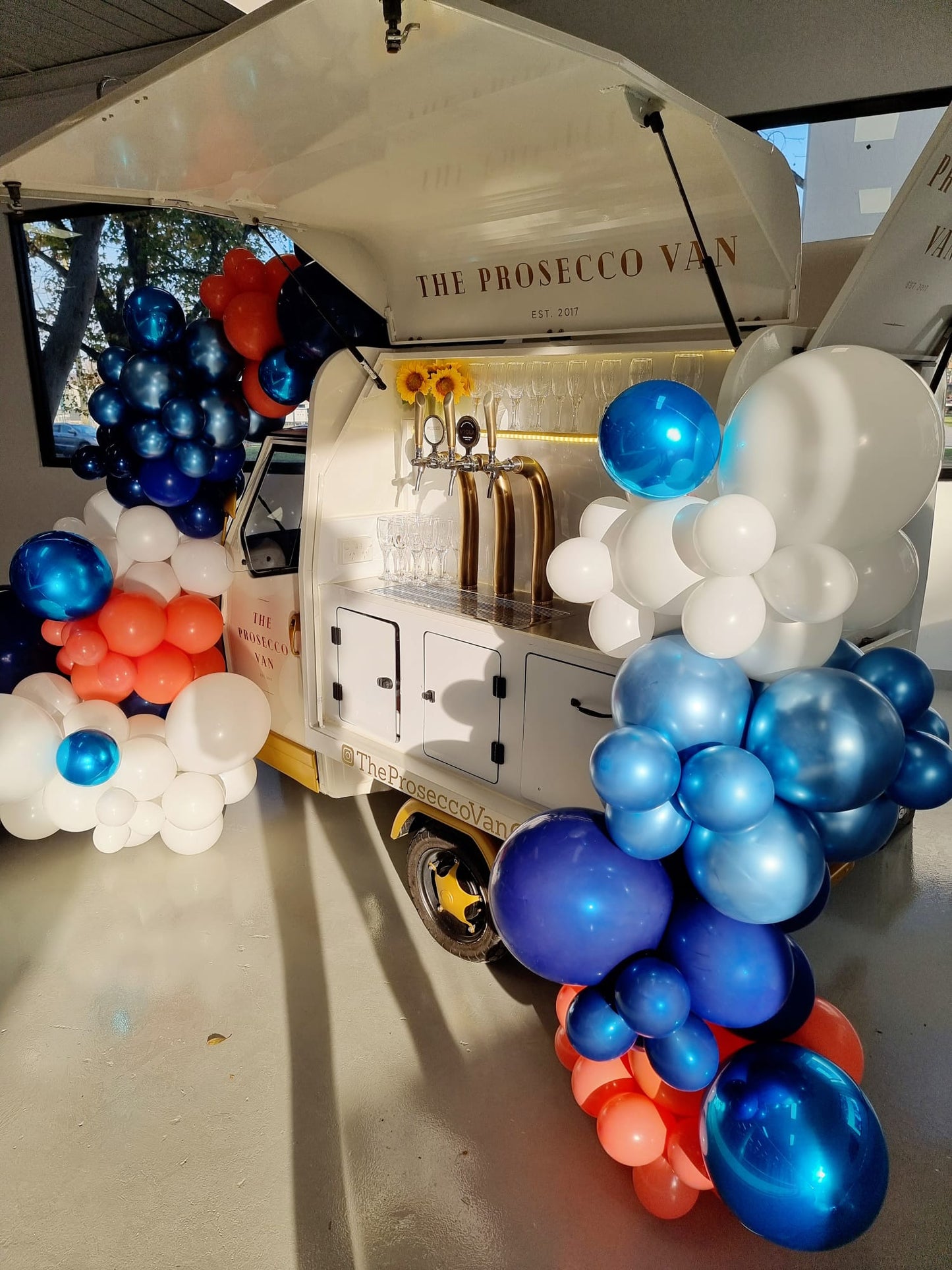 White Blue and Red Prosecco Van Cart Balloon Garland Melbourne Entrance Sunflowers 