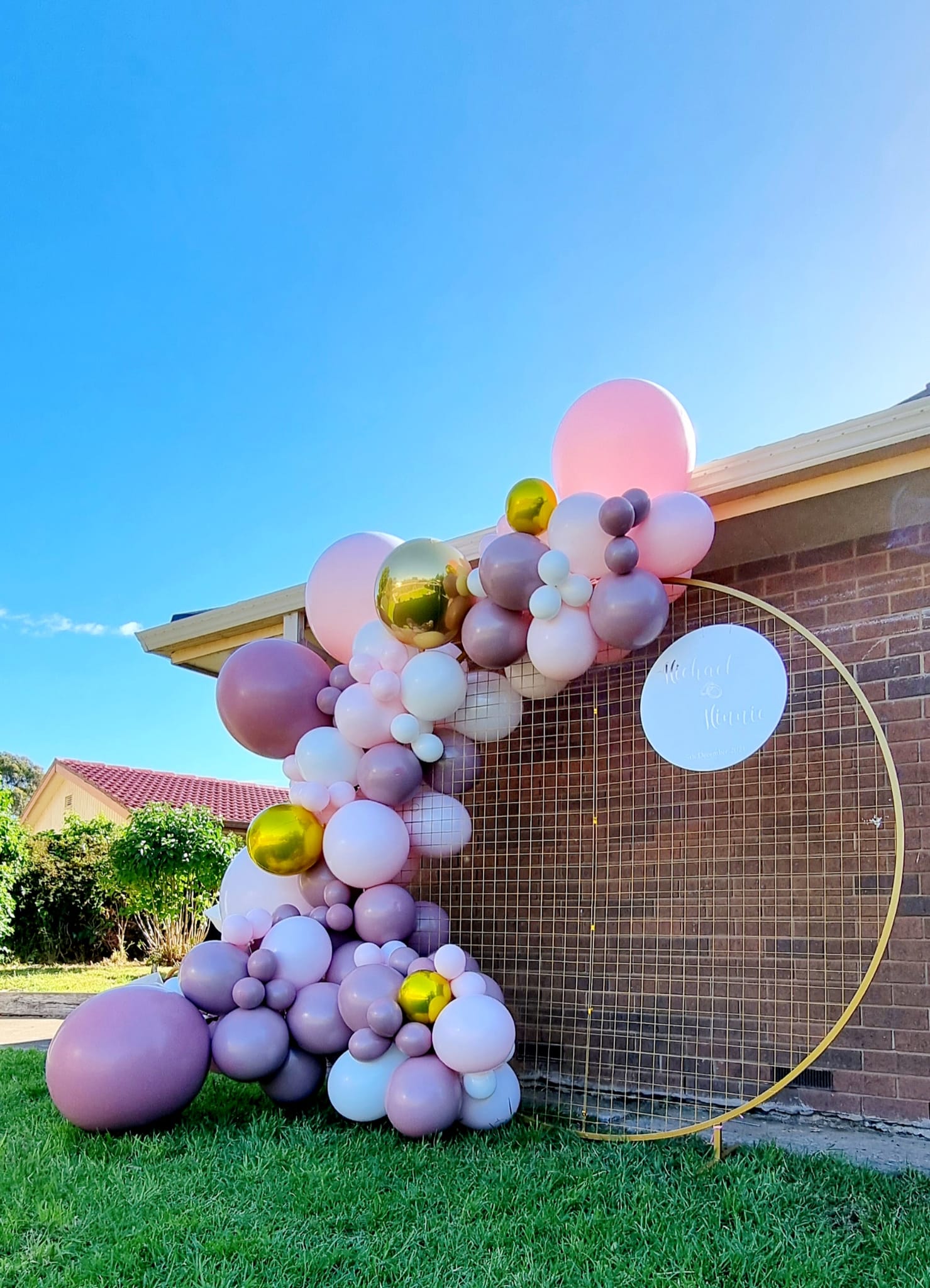 Purple white and gold balloon garland outdoor in St Kilda Melbourne